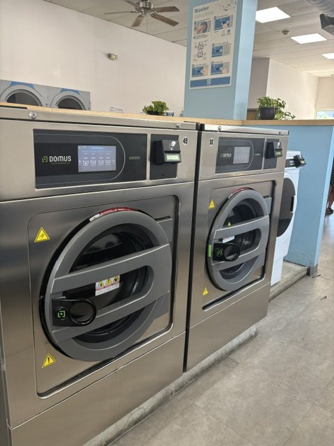 Large stainless high-capacity front-load machines at Scrubs Laundry in Chelsea